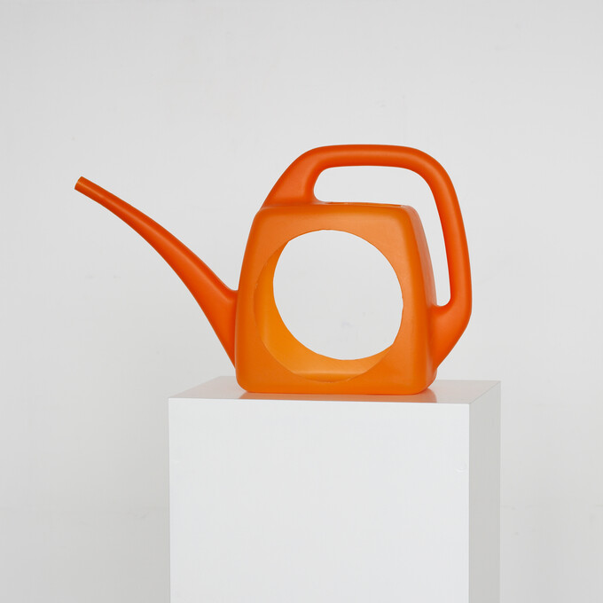 Kunstwerk «Leerer» des Berner Künstlers Peter Gysi aus dem Jahr 2006. Orange-farbige 3-Liter-Giesskanne aus Kunststoff mit den Massen 40×25×11.5 cm. Die Kanne, in die ein kreisrunder Durchblick gefräst wurde, steht auf einem weissen Sockel.
